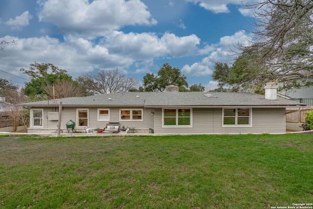 rear view of property with a yard and a patio area