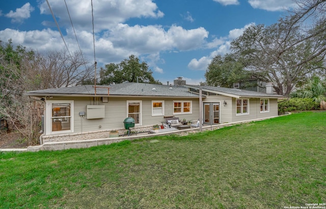 back of house featuring french doors, a patio, and a lawn