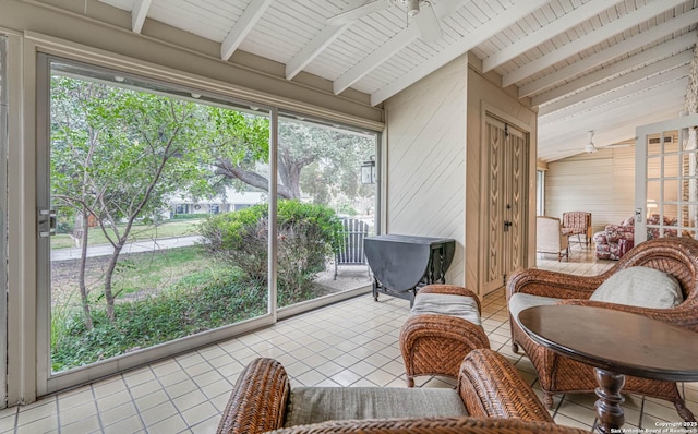 sunroom featuring vaulted ceiling with beams and ceiling fan