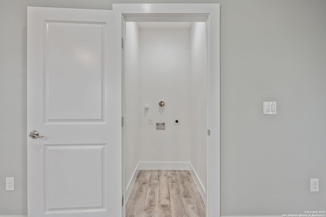 interior space with electric dryer hookup, washer hookup, and light hardwood / wood-style flooring