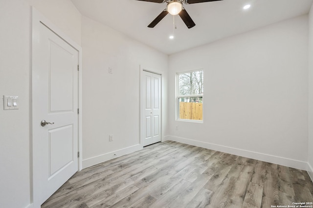 unfurnished bedroom with light hardwood / wood-style flooring, a closet, and ceiling fan