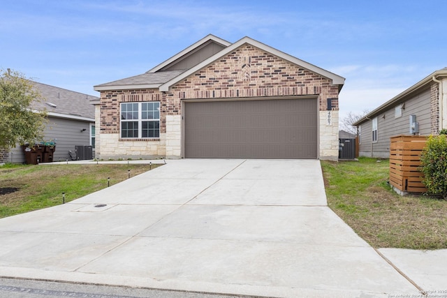 view of front of property with a garage, a front lawn, and central air condition unit