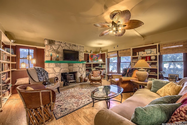 living room featuring ceiling fan and light hardwood / wood-style flooring