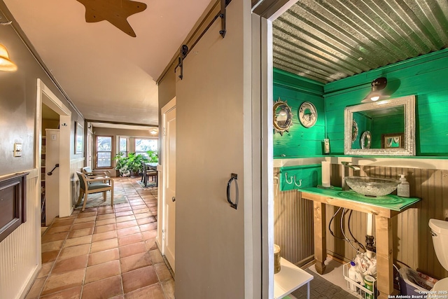 interior space featuring sink, tile patterned floors, and toilet