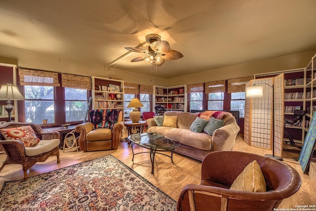 living room with light hardwood / wood-style flooring and ceiling fan