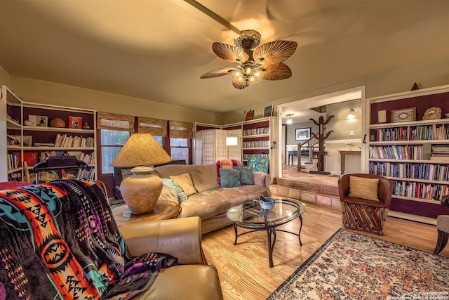 living room featuring ceiling fan and light wood-type flooring