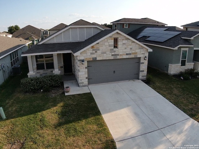 craftsman house featuring central AC unit, a garage, and a front lawn