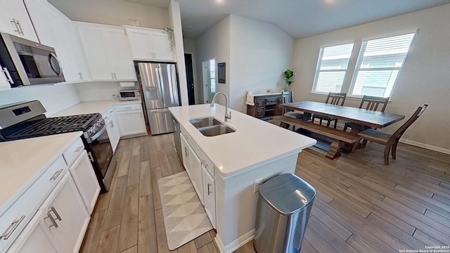 kitchen with white cabinetry, sink, an island with sink, and appliances with stainless steel finishes