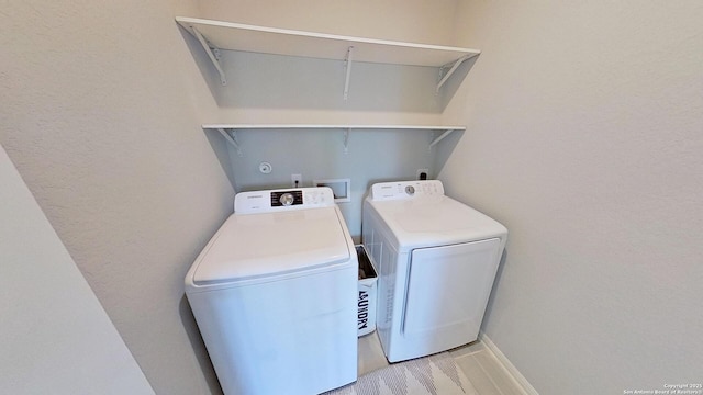 clothes washing area featuring independent washer and dryer