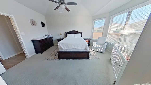 bedroom with lofted ceiling, light carpet, and ceiling fan