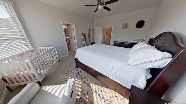 bedroom with carpet floors, ceiling fan, and ensuite bath