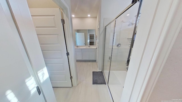 bathroom with vanity, an enclosed shower, and tile patterned flooring