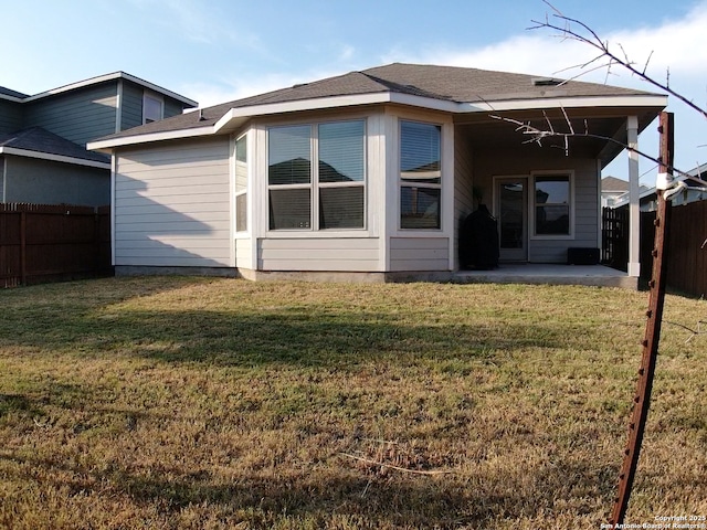 rear view of property featuring a yard and a patio