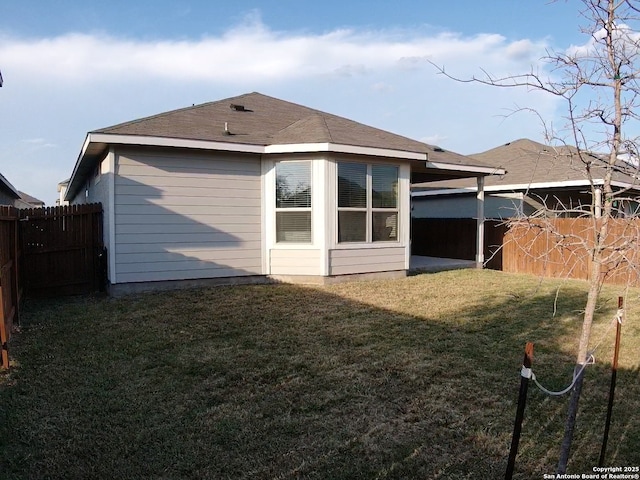 back of house with a lawn