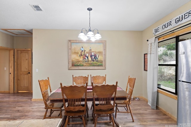 dining room featuring hardwood / wood-style flooring and a notable chandelier