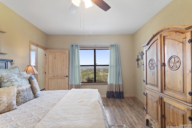 bedroom with hardwood / wood-style floors and ceiling fan