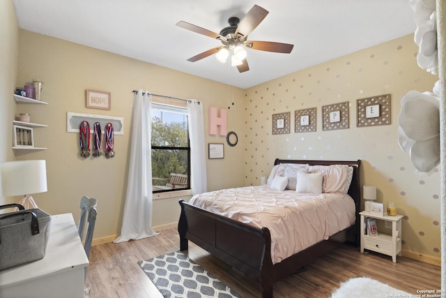 bedroom with hardwood / wood-style flooring and ceiling fan