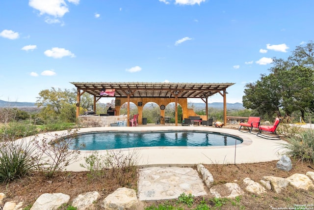 view of swimming pool featuring a pergola and a patio area