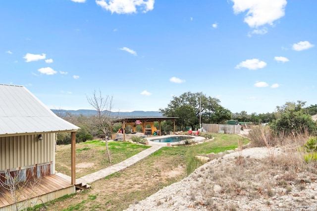 view of yard featuring a gazebo and a pool side deck with mountain view