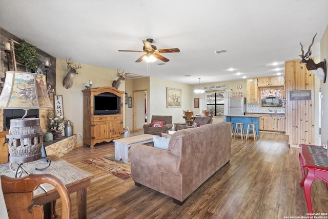 living room featuring dark hardwood / wood-style flooring and ceiling fan