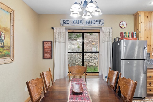 dining area with dark hardwood / wood-style floors and a notable chandelier