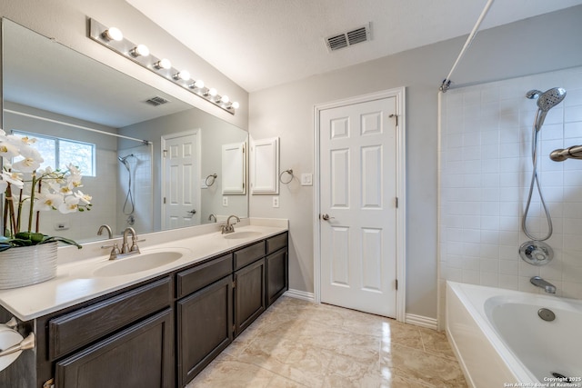 bathroom with vanity and tiled shower / bath combo