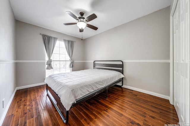 bedroom featuring ceiling fan, dark hardwood / wood-style flooring, and a closet