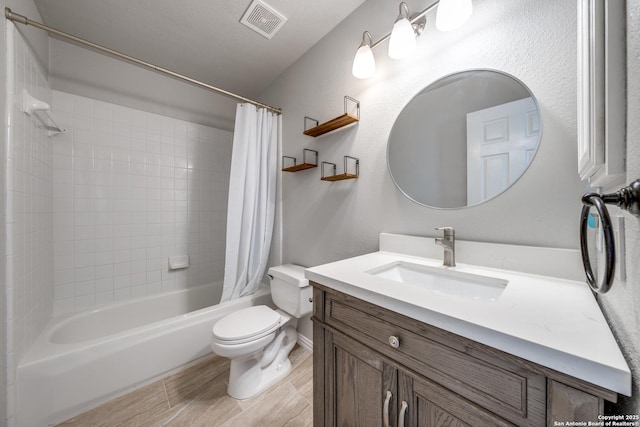 full bathroom featuring vanity, shower / bath combo, and toilet