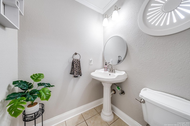 bathroom with crown molding, tile patterned floors, and toilet