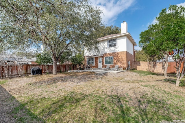 rear view of house with a patio area and a lawn