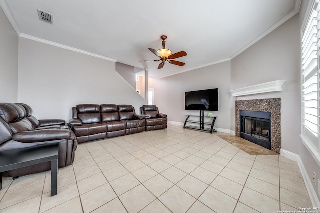 tiled living room with a tiled fireplace, crown molding, and ceiling fan