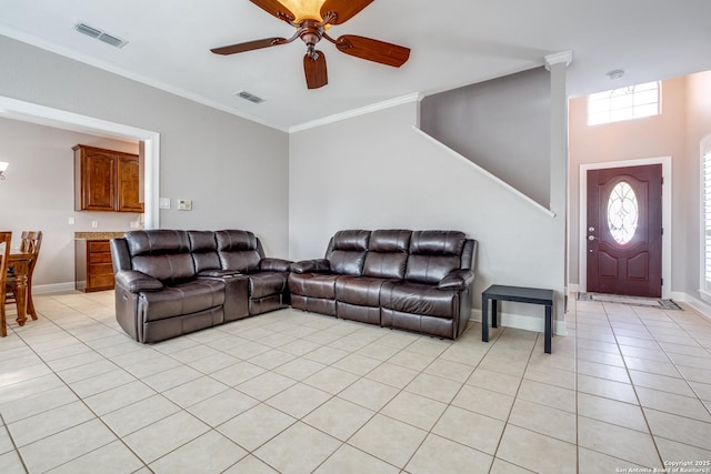 living room featuring light tile patterned flooring, ceiling fan, and ornamental molding