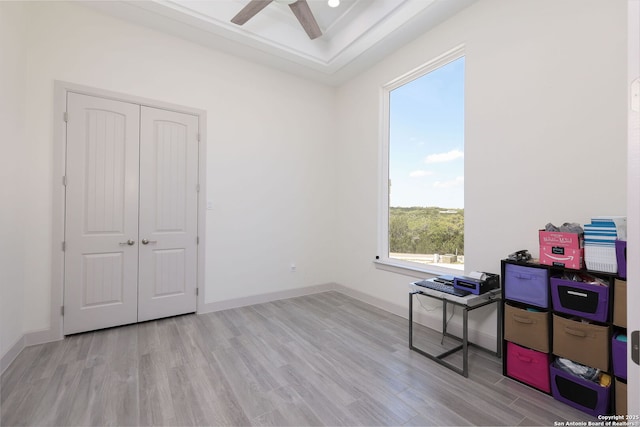 home office featuring light hardwood / wood-style floors and ceiling fan