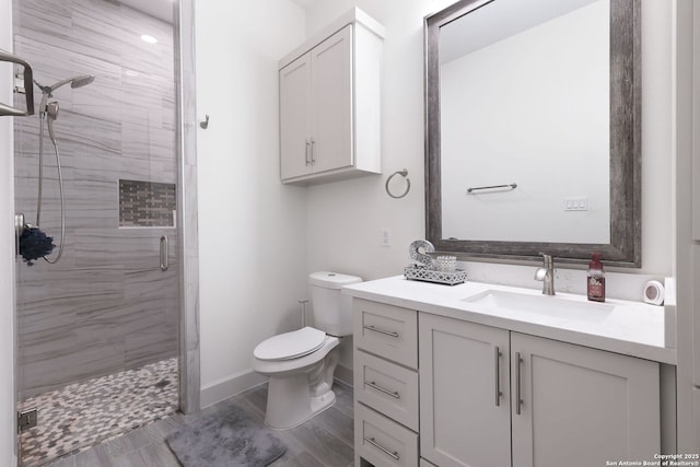 bathroom with vanity, toilet, and a shower with shower door