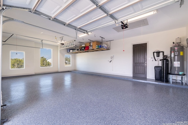 garage with a garage door opener and water heater