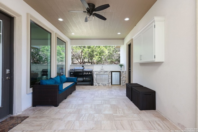 view of patio with sink, ceiling fan, and exterior kitchen