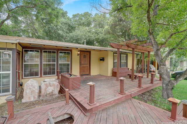 wooden deck featuring a pergola