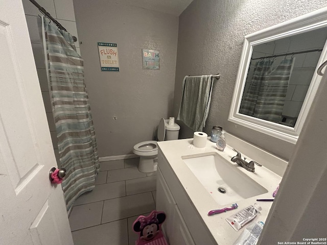 bathroom featuring vanity, walk in shower, tile patterned floors, and toilet