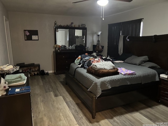 bedroom featuring hardwood / wood-style flooring and ceiling fan