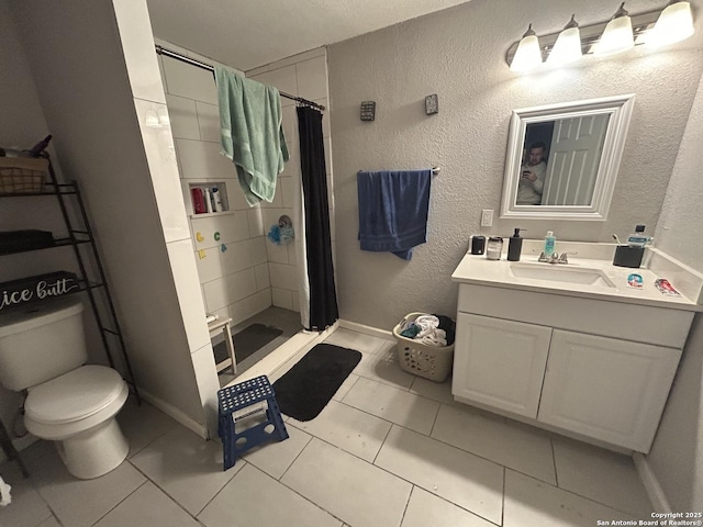 bathroom with tile patterned flooring, vanity, curtained shower, and toilet