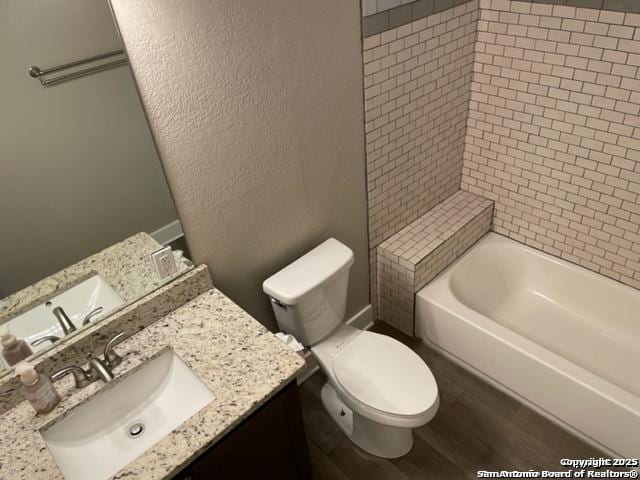 bathroom with hardwood / wood-style flooring, vanity, and toilet