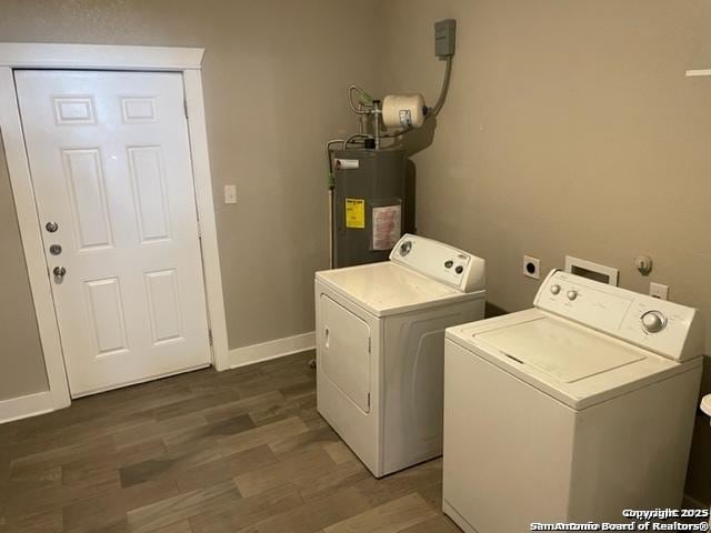 laundry area featuring dark hardwood / wood-style flooring, washing machine and dryer, and water heater