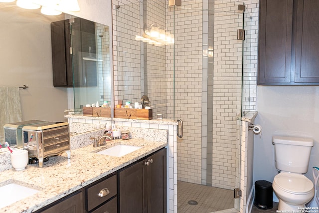 bathroom with toilet, vanity, and walk in shower