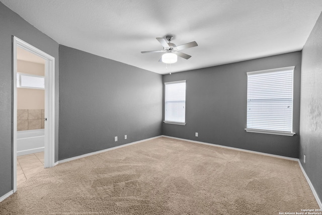 empty room with light carpet and ceiling fan