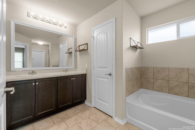 bathroom with vanity, tile patterned floors, and a bathing tub