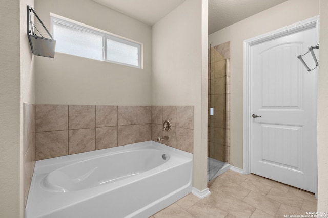 bathroom with shower with separate bathtub and tile patterned flooring