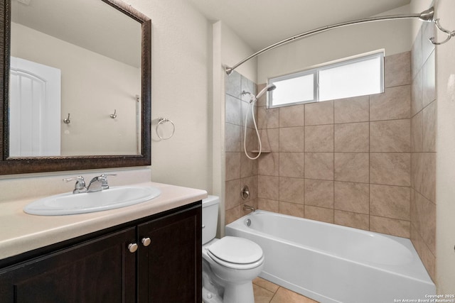 full bathroom with tiled shower / bath, tile patterned floors, toilet, and vanity