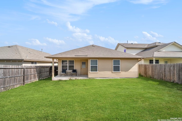 back of house featuring a lawn and a patio area