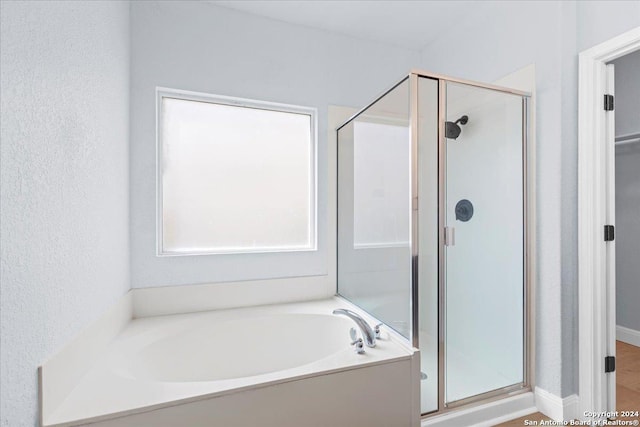 bathroom featuring separate shower and tub