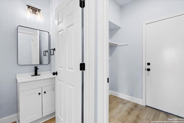 bathroom with hardwood / wood-style flooring and vanity